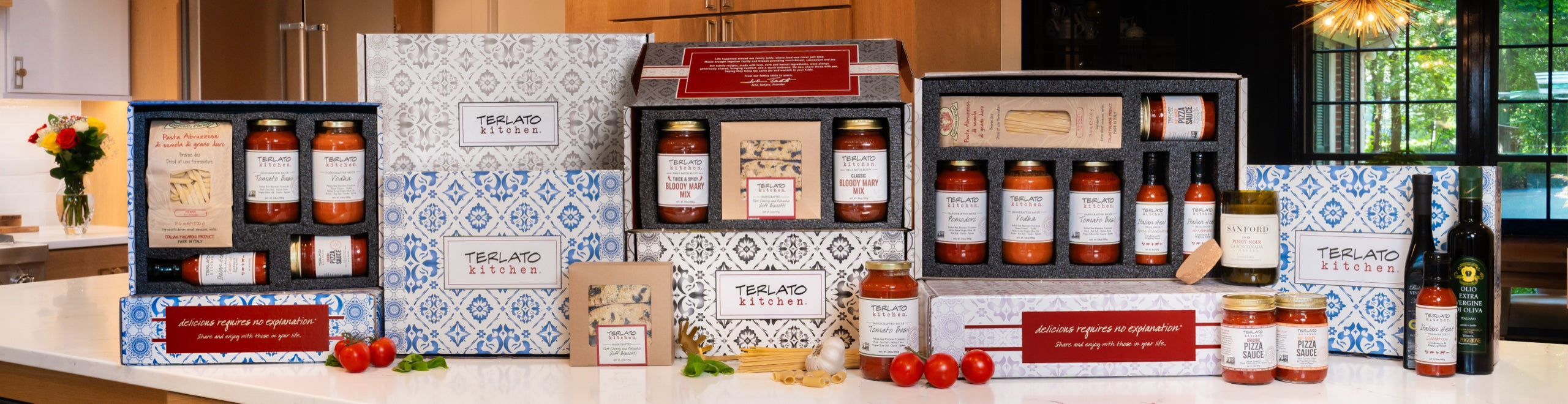 Terlato Kitchen patterned gift boxes with Italian sauces, pasta, biscotti and olive oil arranged on a kitchen counter